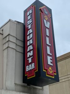 The Ville Triple-Sided Flag Mounted Sign