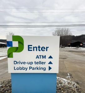 Flat routed aluminum directional panels reading “ENTER – ATM – DRIVE-UP TELLER, LOBBY PARKING,” fabricated and installed by Adams Signs & Graphics for DoverPhila in Uhrichsville, Ohio.
