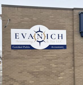 Custom aluminum composite wall signs manufactured and installed by Adam Signs for Evanich Accounting & Tax LLC in Minerva, Ohio, featuring cut‑to‑shape panels with vinyl lettering.
