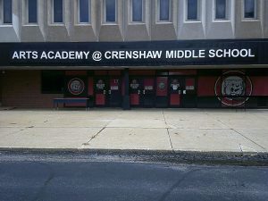Dimensional letter sign reading Arts Academy at Crenshaw Middle School mounted above the building entrance with Bulldog mascot door graphics | Adams Signs & Graphics