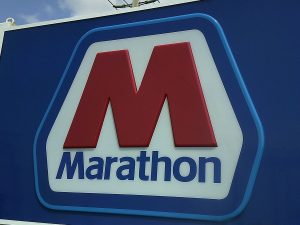 Close-up of a Marathon gas station sign face featuring the red M logo and Marathon wordmark on a blue background | Adams Signs & Graphics