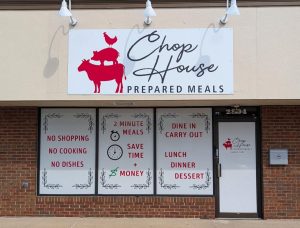 Custom vinyl window graphics on the storefront of Chop House Prepared Meals, featuring the brand logo and menu highlights for dine in, carry out, lunch, dinner, and dessert | Adams Signs & Graphics